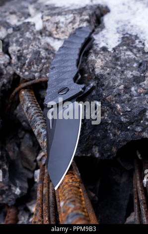 Sharpened knife. Black knife. Vertical shot of a black knife. Stock Photo