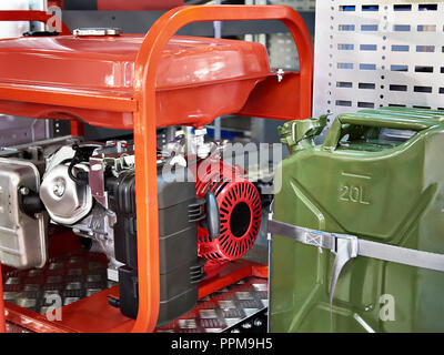 Gasoline generator and canister with fuel in car support Stock Photo