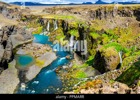 High angle view of of the Sigoldugljufur canyon with many small waterfalls and the blue river in Highlands of Iceland in summer