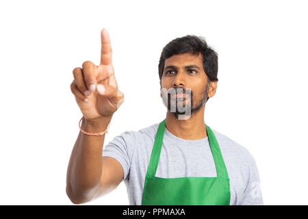 Hypermarket or supermarket indian man employee touching invisible display with index finger with black copy space for advertising isolated on white ba Stock Photo