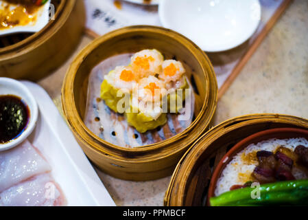 Chinese Cantonese dimsum meal served in traditional bamboo steamer Stock Photo