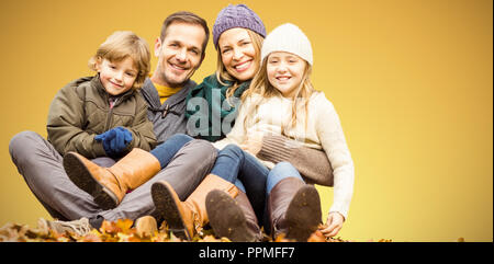 Composite image of portrait of happy family sitting on field at park Stock Photo