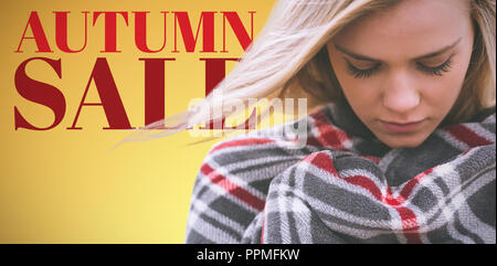 Composite image of close up of a woman wraped in a blanket Stock Photo