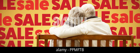Composite image of  senior couple embracing on a bench Stock Photo