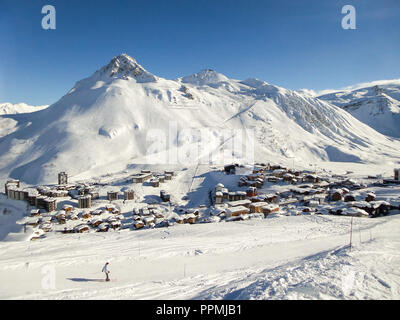 Ski resort of Tignes in winter, ski slope and village of Tignes le lac in the background Stock Photo