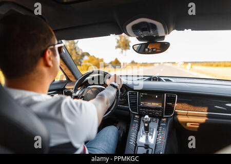 stylish young business man with sunglasses travels in a luxury car Stock Photo
