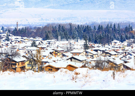 Houses with snow roofs panorama banner of bulgarian ski resort Bansko, Bulgaria