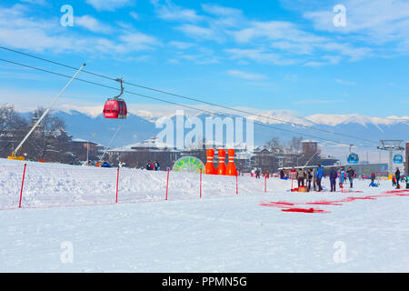 Bansko, Bulgaria - January 13, 2017: Winter ski resort Bansko, attractions, people walking and skiing and mountains view Stock Photo
