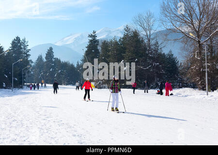 Bansko, Bulgaria - January 13, 2017: Winter ski resort Bansko, attractions, people walking and skiing and mountains view Stock Photo