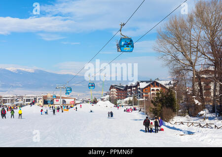 Bansko, Bulgaria - January 13, 2017: Winter ski resort Bansko, ski slope, people skiing and mountains view Stock Photo