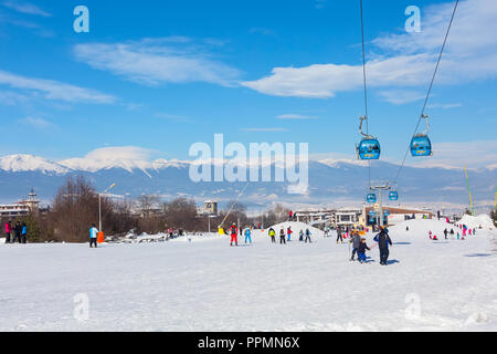 Bansko, Bulgaria - January 13, 2017: Winter ski resort Bansko, ski slope, people skiing and mountains view Stock Photo