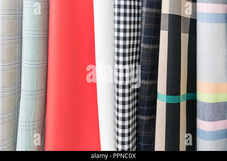 Samples of a variety of fabrics, of varying quality and color, arranged in waves Stock Photo