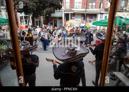 TORONTO, ON, CANADA - JULY 29, 2018: A mariachi band plays in front of a crowd in Toronto's vibrant Kensington Market. Stock Photo