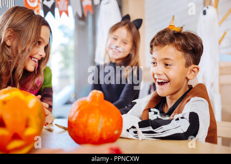 Handsome smiling schoolboy wearing skeleton costume for Halloween party Stock Photo