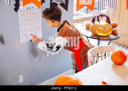 Boy wearing skeleton Halloween costume crossing the last day of October Stock Photo