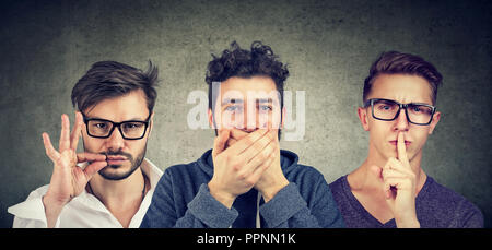 Keep a secret be quiet concept. Three secretive men keeping mouth shut. Stock Photo