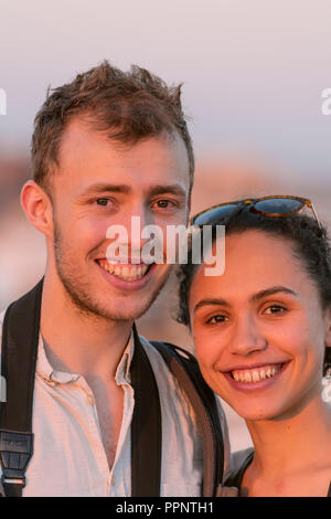 Laughing young woman and young man looking into the camera, couple, Plaza de la Encarnacion, Seville, Andalusia, Spain Stock Photo