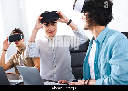 multicultural businessmen with virtual reality headsets at modern office Stock Photo