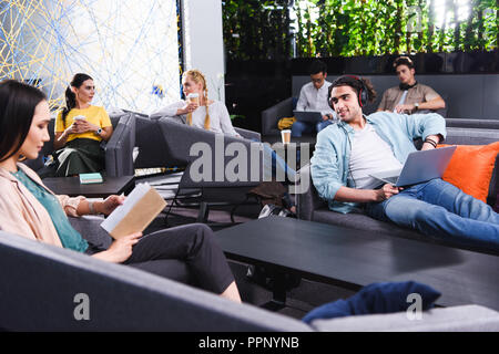 group of multicultural business people working and talking at modern coworking office Stock Photo