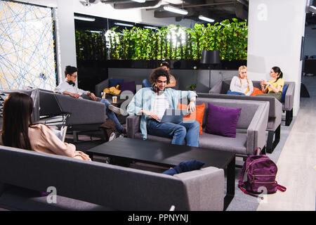 group of multicultural business people working and talking at modern coworking office Stock Photo