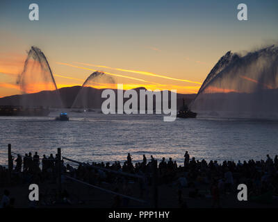 Canadian Fire Boat sunset water spray Stock Photo - Alamy
