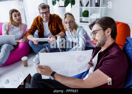 multicultural colleagues working on startup project in office Stock Photo