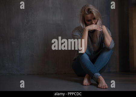 Mental health. Young woman lying on the floor, concept of stress or post-traumatic disorder Stock Photo