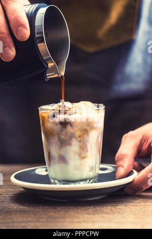 Close-up a barista making fres ice coffee on barcounter. Stock Photo