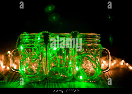 Green Fairy Light in a Glass Jars in the Dark Low-Key Photography. Stock Photo