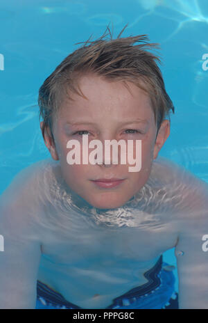 Ten year on boy in a swimming pool. Stock Photo
