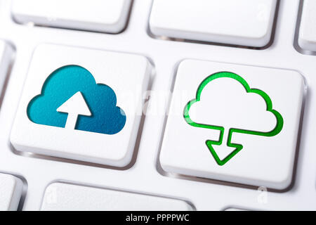 Macro Of Cloud Upload And Download Buttons On A White Keyboard Stock Photo