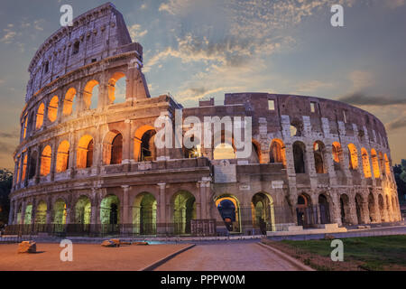 Roman Coliseum enlighted in the evening under the clouds Stock Photo
