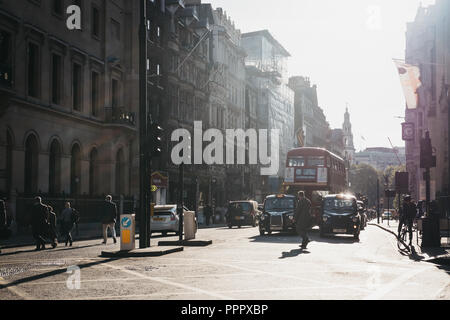 London, UK - September 17, 2018: People crossing the road on a pedestrian crossing in front of red double decker bus and black cabs in the City of Lon Stock Photo