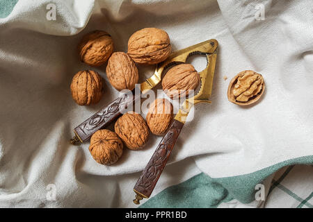 walnuts and vintage nutcracker with carved wooden handle Stock Photo