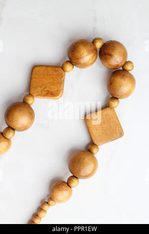 Wooden beads on white background, necklace top view Stock Photo