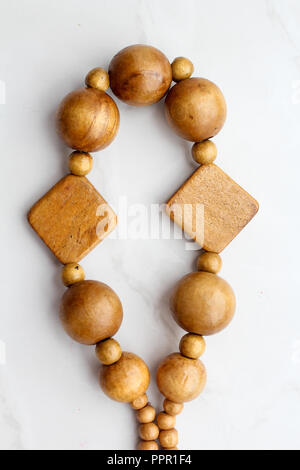 Wooden beads on white background, necklace top view Stock Photo