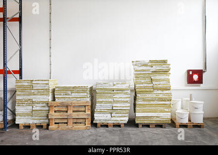 Pallets with construction material in storage room Stock Photo