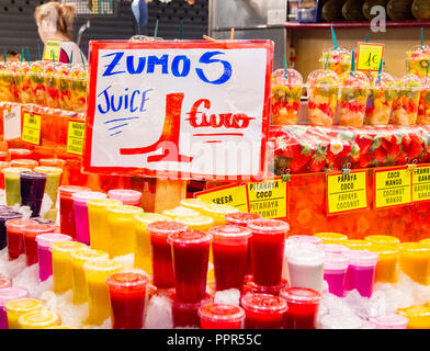 Fresh fruit juices and smoothies in La Boqueria market just of Las Ramblas in Barcelona, Spain Stock Photo