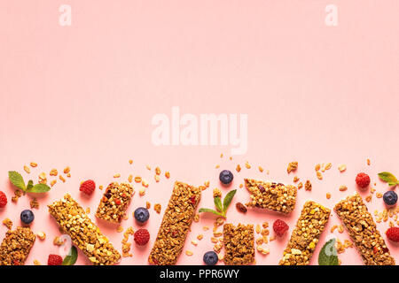 Cereal bars on a bright pastel background, top view. Stock Photo