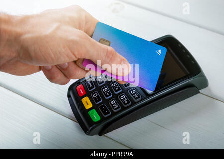 hand with credit card making contactless payment transaction Stock Photo
