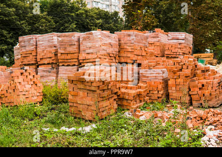 Stack of red brick for construction. Common quality building bricks stacked ready for use. Stock Photo
