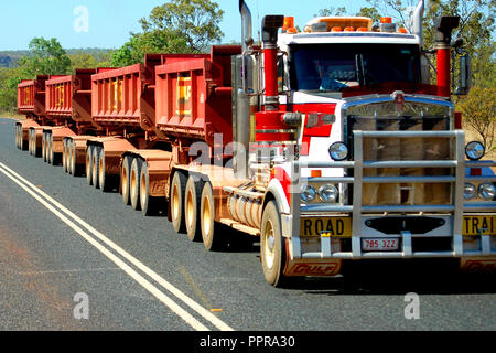 TRAY ROAD TRAIN ON OUTBACK ROAD IN WESTERN AUSTRALIA Stock Photo