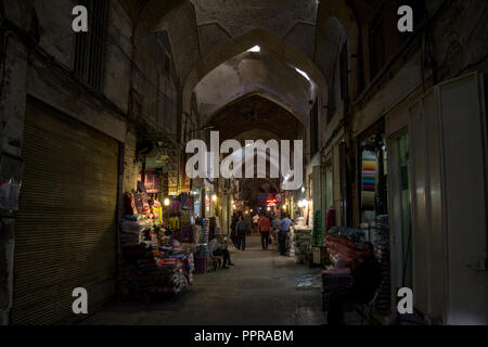 ISFAHAN, IRAN - AUGUST 8, 2018: Street of the Isfahan bazar in the evening in a covered alley of the market. Symbol of the Persian architecture, it's  Stock Photo