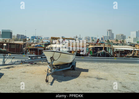 Boats moored in Park in central Doha, Qatar, Arabia, with some of the buildings from the city's commercial port in the background. Stock Photo