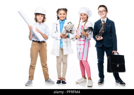 happy schoolchildren in costumes of different professions isolated on white Stock Photo