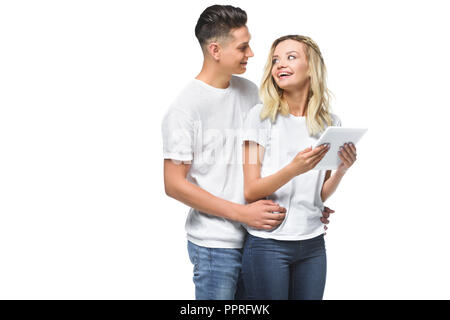 happy couple hugging and using tablet together isolated on white Stock Photo