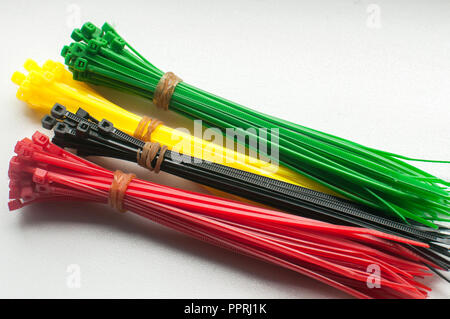 Different colors of plastic nylon cable ties with self-locking teeth closeup on white background Stock Photo