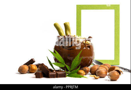 Hazelnut spread with marijuana leaves in a jar isolated Stock Photo