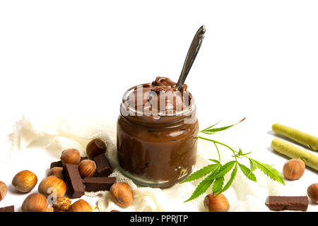Hazelnut spread with marijuana leaves in a jar isolated Stock Photo