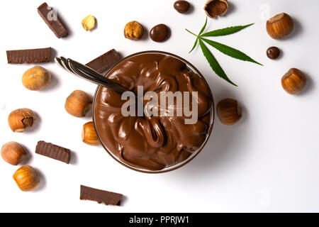 Hazelnut spread with marijuana leaves in a jar isolated Stock Photo